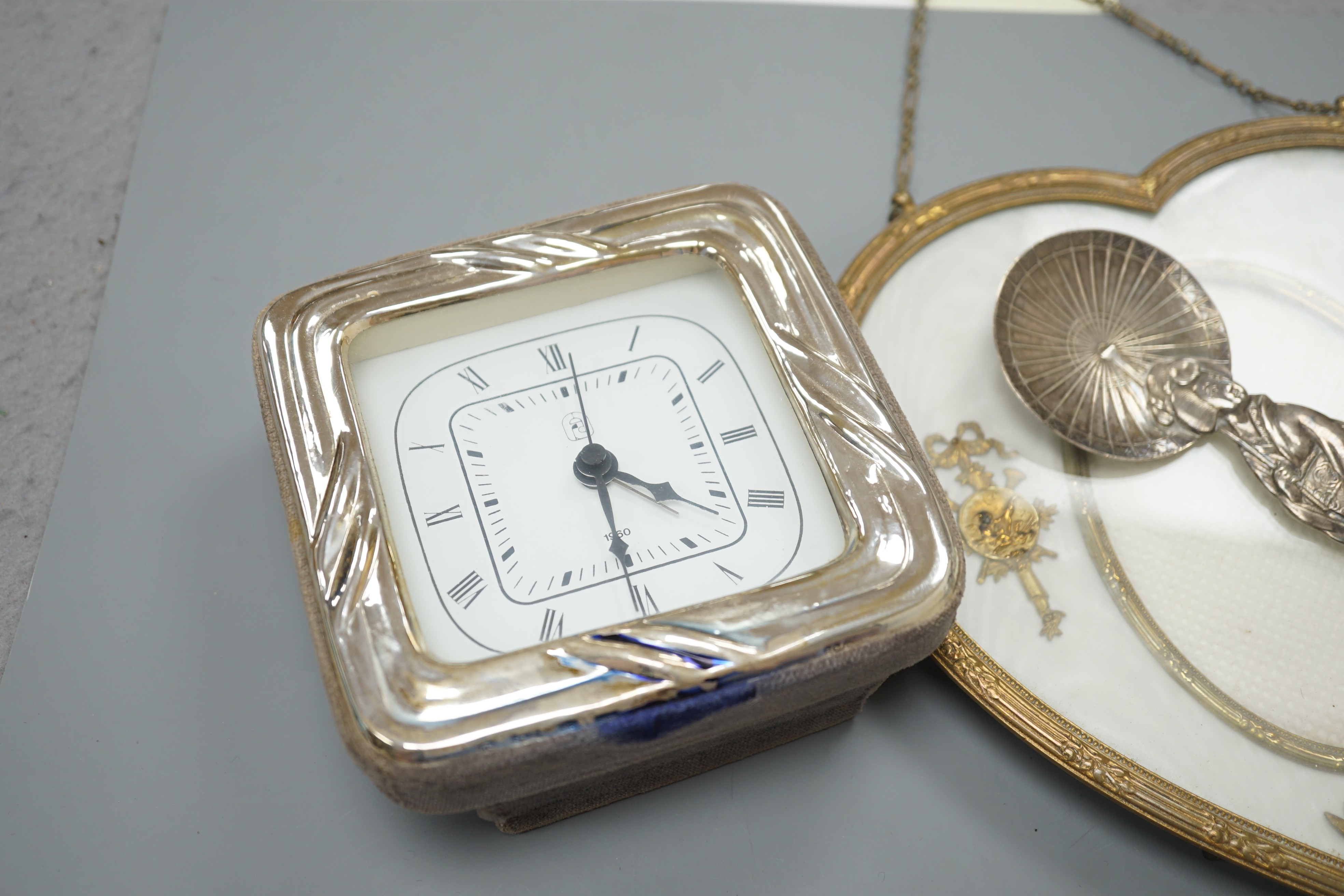 A 19th century gilt heart-shaped frame, A Japanese sterling figural spoon, a 1930's silver cream jug and modern silver mounted clock, photo frame 20 cms high.